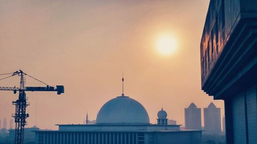 Low angle view of buildings against sky at sunset