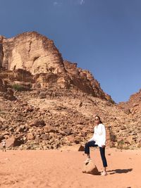 Full length of woman on rock against sky