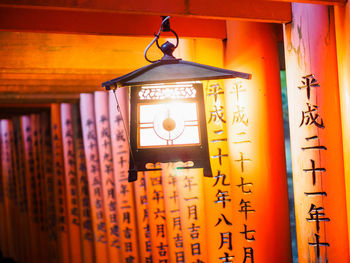 Illuminated lanterns hanging on wall at home