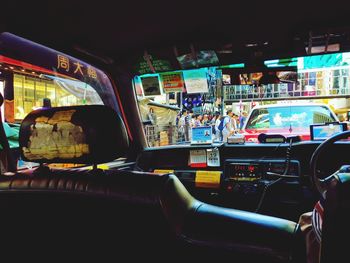 Cars on illuminated street in city