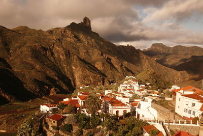 Scenic view of valley and mountains against cloudy sky