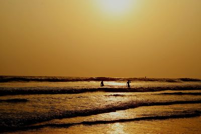 Scenic view of sea against clear sky during sunset