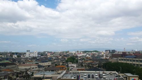 Buildings against cloudy sky