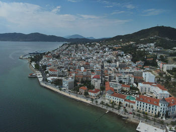 High angle view of townscape by sea against sky