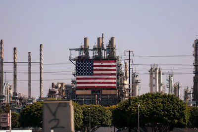 Flag in city against clear sky