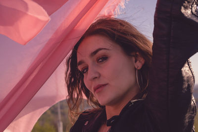 Portrait of beautiful young woman with scarf 