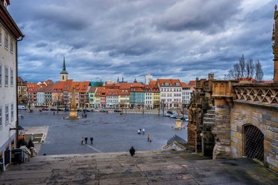 View of harbor in city against sky