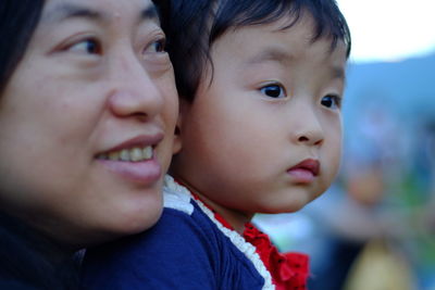 Close-up portrait of cute boy looking away