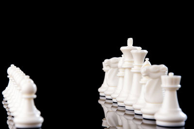 Close-up of chess pieces against black background