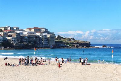 People at bondi beach against blue sky and beautiful sunny day background 
