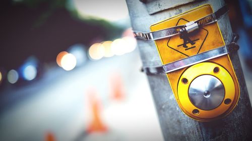 Tilt shot of crossing sign on metallic pole in city