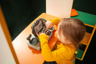 High angle view of boy playing piano