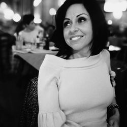 Smiling mid adult woman at restaurant