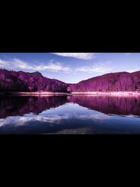 Scenic view of lake against sky at night