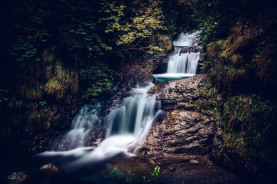 Relaxing flow of water in the enchanted valley italian alps landscape