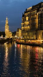 Illuminated buildings in amsterdam city at night