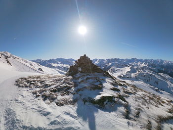 Scenic view of snow covered mountains against clear sky