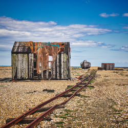 Old fishing shack against the sky with fishing boat on dungeness beach.