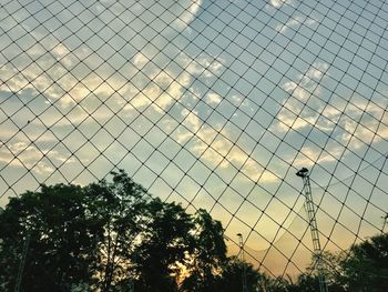 Low angle view of building seen through chainlink fence