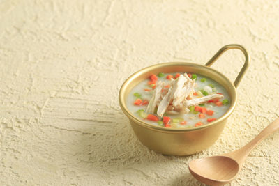 Korean dakjuk porridge, chicken congee with shredded chicken breast, carrot, and spring onion