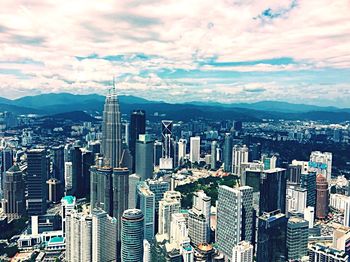 High angle view of modern buildings in city against sky