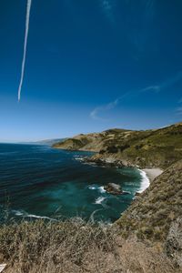 Scenic view of sea against blue sky