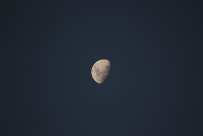 Low angle view of moon against clear sky at night