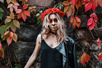 Portrait of young woman with plants