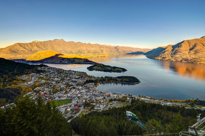 Scenic view of mountains and lake against blue sky