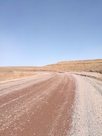 Sand dunes in desert against clear sky