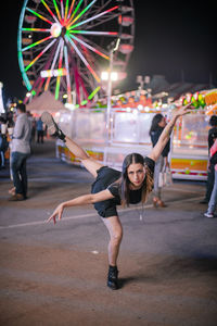 Woman enjoying music in city at night