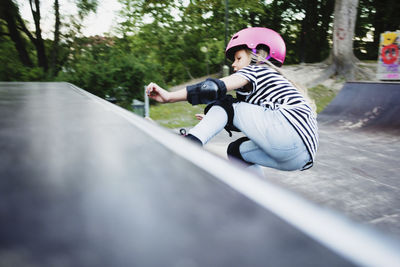 Girl skateboarding on ramp at park