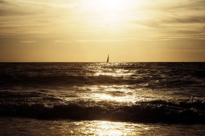 Silhouette of sailboat in sea