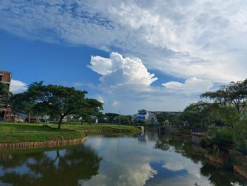 Scenic view of lake by building against sky