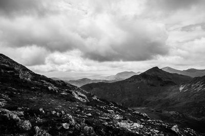 Idyllic view of mountains against cloudy sky