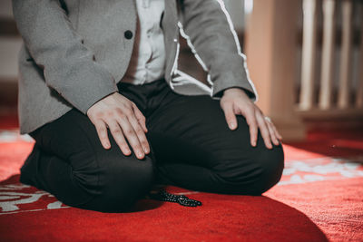 Low section of people sitting on floor