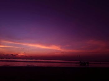 Scenic view of sea against dramatic sky during sunset