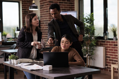 Young woman using laptop at table