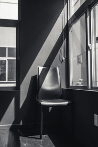 Empty chair by window at home