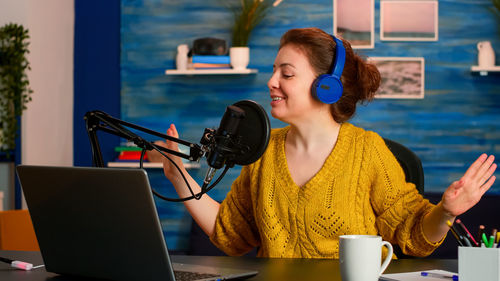 Woman singing at recording studio