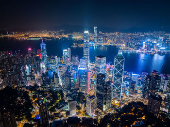 High angle view of illuminated buildings in city at night