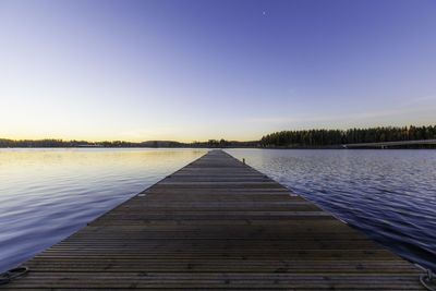 Jetty over lake against sky