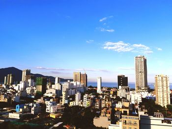 Buildings in city against blue sky