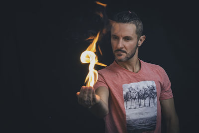 Man holding a fire in his hands. 