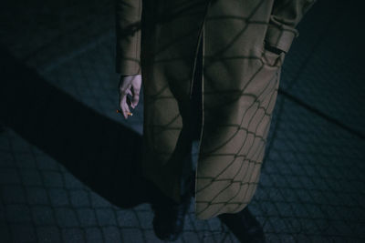 Low section of woman walking on tiled floor