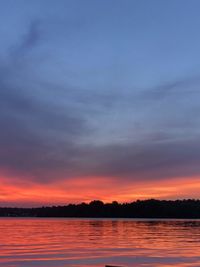 Scenic view of lake against romantic sky at sunset