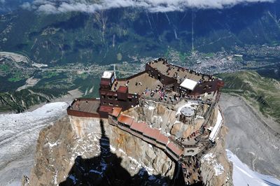 High angle view of land and sea against mountains