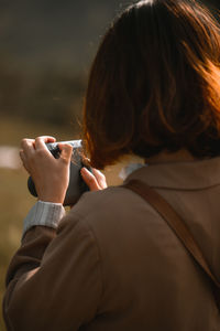 Close-up of woman using camera