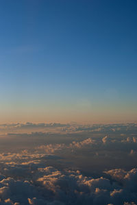 Aerial view of landscape against blue sky