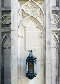 Low angle view of cross against building